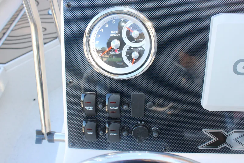 Slide: The Image of Dashboard of 2026 Xpress H20B Bay boat with gauges and switches. - 13