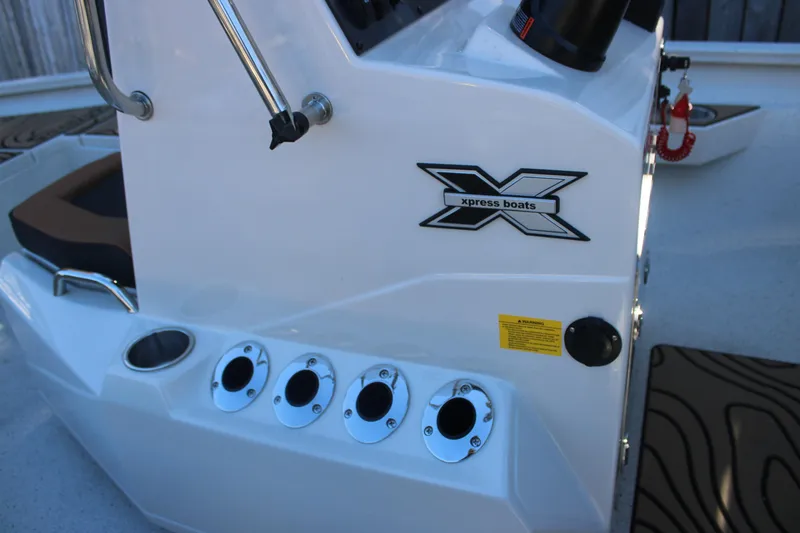 Slide: The Image of 2026 Xpress H20B Bay boat console with logo and rod holders. - 15