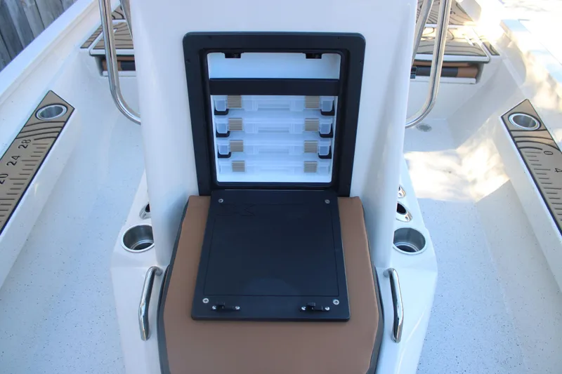 Slide: The Image of 2026 Xpress H20B Bay boat with open storage compartment and measuring rulers. - 18