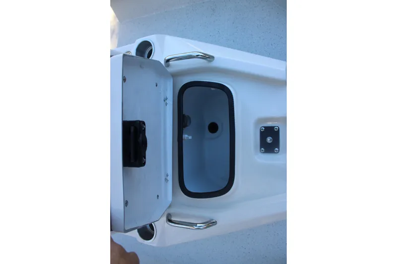 Slide: The Image of 2026 Xpress H20B Bay boat storage compartment with open lid and handle. - 19