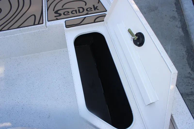 Slide: The Image of Open storage compartment on 2026 Xpress H20B Bay boat with SeaDek flooring. - 24