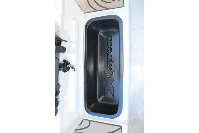 Slide: The Image of 2026 Xpress H20B Bay boat storage compartment with logo. - 25