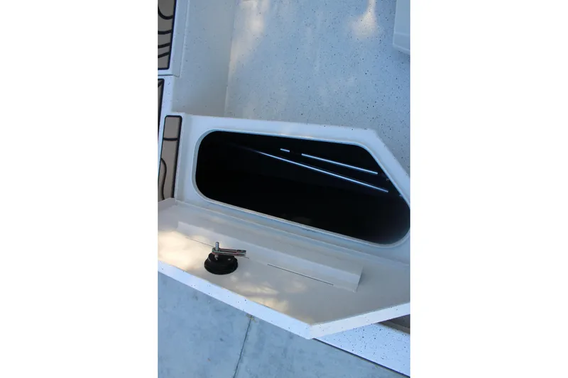 Slide: The Image of Storage compartment of 2026 Xpress H20B Bay boat, featuring sleek design and latch. - 26