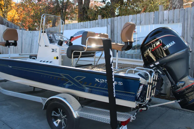Slide: The Image of 2026 Xpress H20B Bay boat with Yamaha engine, parked on a trailer. - 3