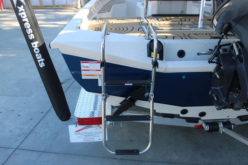 Slide: The Image of 2026 Xpress H20B Bay boat rear view with ladder and motor. - 6