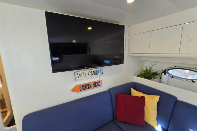 Slide: The Image of Interior of a 1993 Giorgi 46 yacht with TV, colorful cushions, and decor. - 113