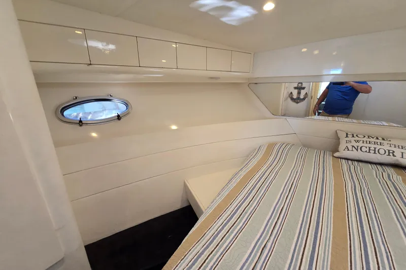 Slide: The Image of Cozy cabin interior of 1993 Giorgi 46 yacht with striped bedding and nautical decor. - 122