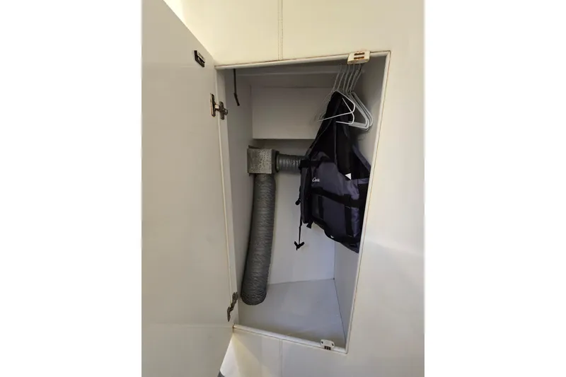 Slide: The Image of Cabinet interior with hangers, life jacket, and ventilation pipe in Giorgi 46, 1993 model. - 124