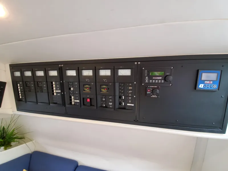Slide: The Image of Electrical control panel inside a 1993 Giorgi 46 boat, featuring multiple switches and meters. - 19