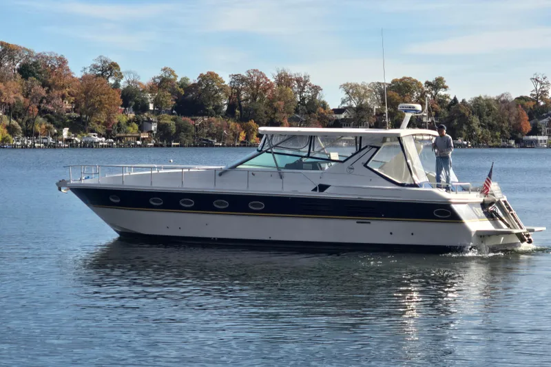 Slide: The Image of Luxury Giorgi 46 yacht from 1993 cruising on a serene lake with autumn foliage. - 2