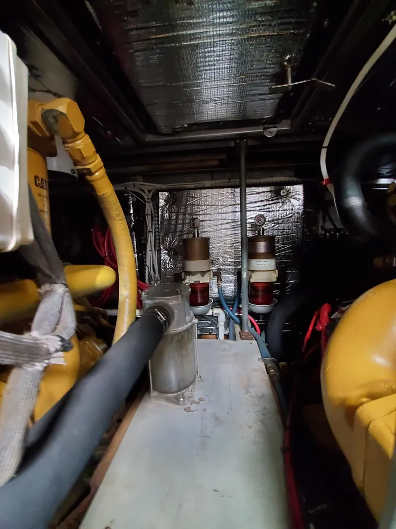 Slide: The Image of Engine room of a 1993 Giorgi 46 boat, featuring various mechanical components and wiring. - 37