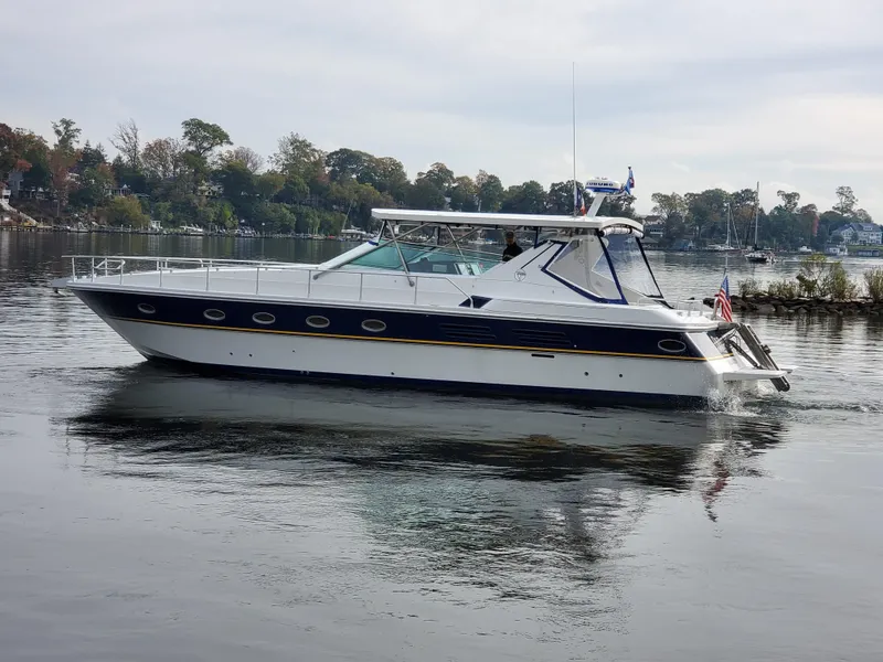 Slide: The Image of 1993 Giorgi 46 yacht cruising on calm waters with scenic shoreline background. - 6