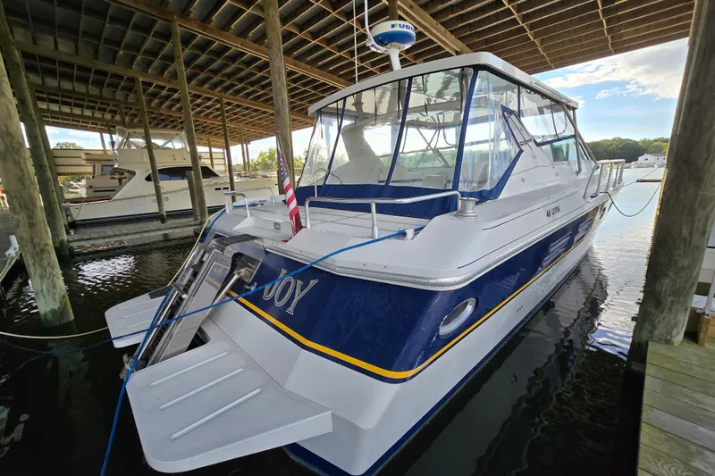 Slide: The Image of 1993 Giorgi 46 boat docked under a wooden shelter, featuring a sleek design. - 83