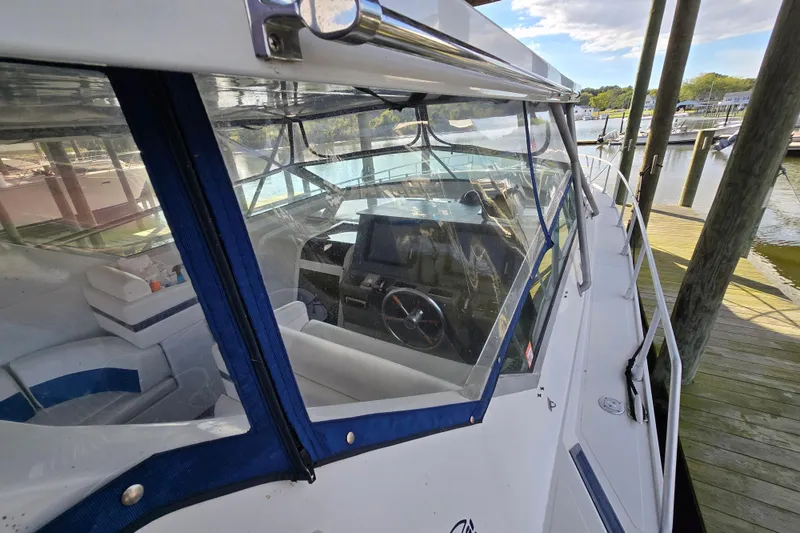 Slide: The Image of 1993 Giorgi 46 boat docked, showcasing cockpit and interior seating. - 86
