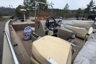 Slide: The Image of 2007 Alumacraft 1756 All Weld MV CC boat with beige seating and steering console. - 5