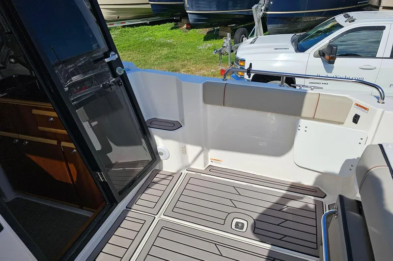 Slide: The Image of 2024 Cutwater C-248 Coupe boat interior with open door and deck view. - 11