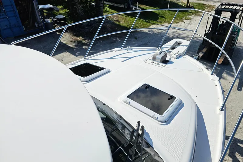 Slide: The Image of 2024 Cutwater C-248 Coupe boat deck with hatches and railing, viewed from above. - 14