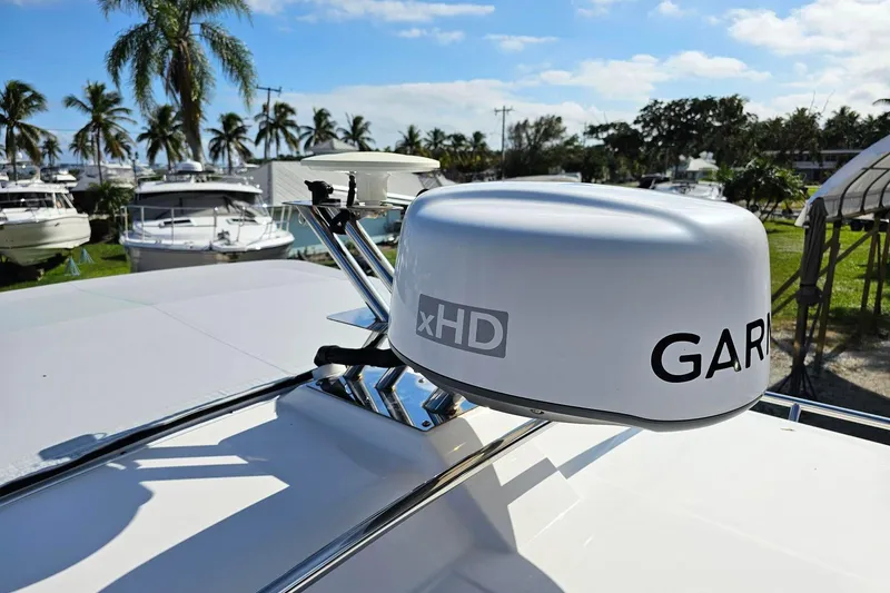 Slide: The Image of 2024 Cutwater C-248 Coupe with Garmin xHD radar, surrounded by palm trees and boats. - 15