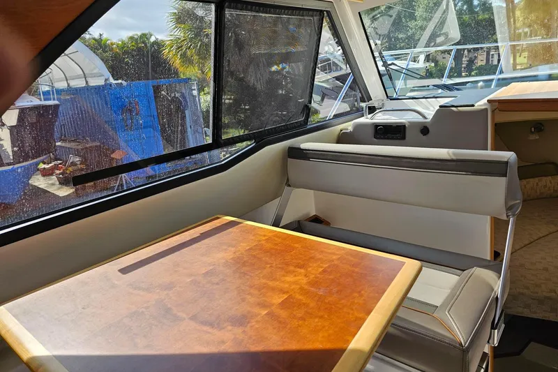 Slide: The Image of Interior of 2024 Cutwater C-248 Coupe with seating and wooden table. - 23