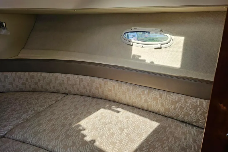 Slide: The Image of 2024 Cutwater C-248 Coupe interior cabin with patterned seating and small window. - 32