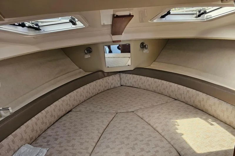 Slide: The Image of 2024 Cutwater C-248 Coupe interior cabin with beige upholstery and overhead windows. - 34