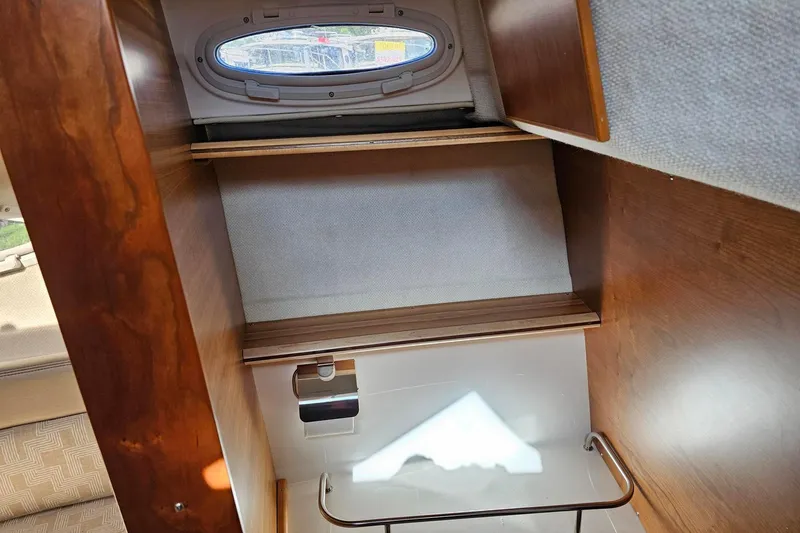 Slide: The Image of 2024 Cutwater C-248 Coupe interior with wooden cabinetry and small window. - 37