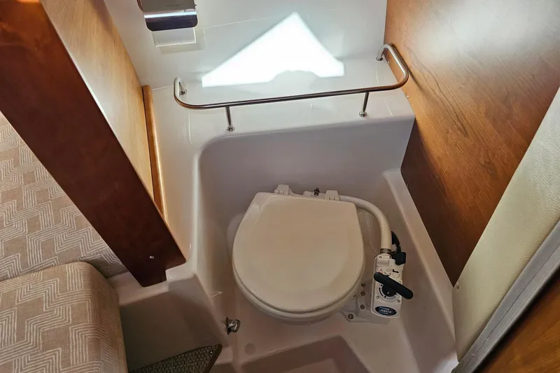 Slide: The Image of 2024 Cutwater C-248 Coupe boat interior with compact marine toilet. - 38