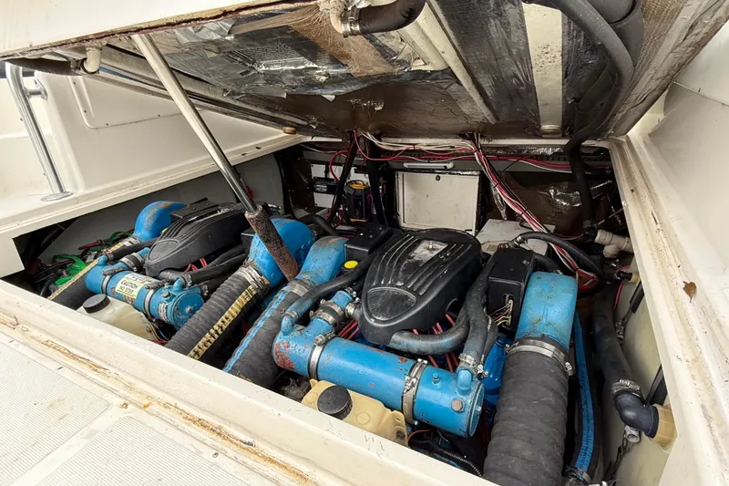 Slide: The Image of Engine compartment of a 1997 Pursuit 2800 Offshore boat, showcasing dual engines and wiring. - 14
