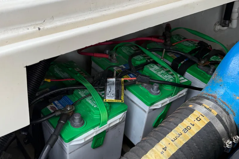 Slide: The Image of Batteries in a 1997 Pursuit 2800 Offshore boat, secured with green straps. - 16