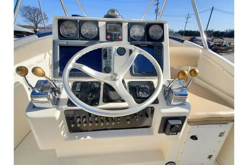 Slide: The Image of 1997 Pursuit 2800 Offshore boat dashboard with steering wheel and control panel. - 20