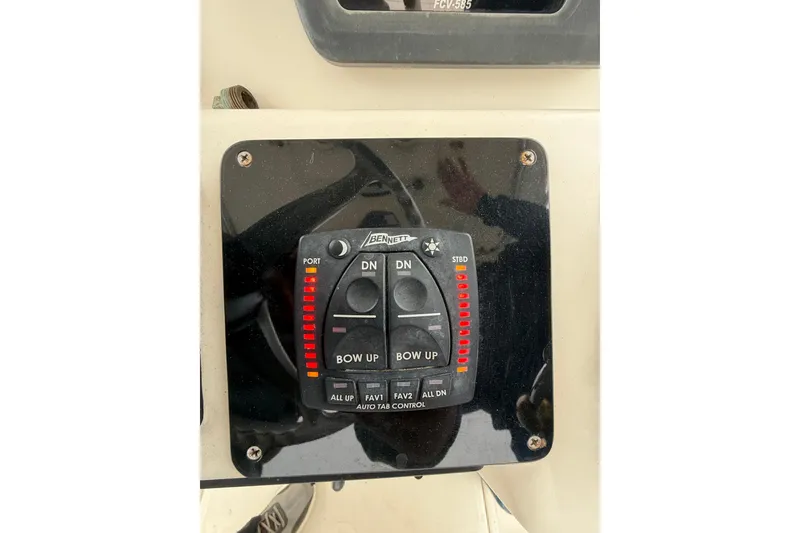 Slide: The Image of 1997 Pursuit 2800 Offshore boat control panel with Bennett trim tab switches. - 24