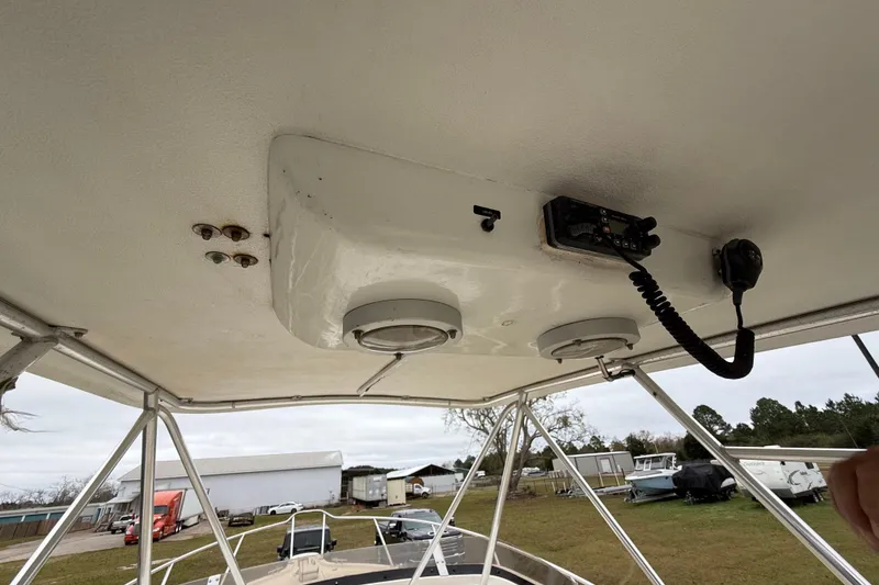 Slide: The Image of 1997 Pursuit 2800 Offshore boat roof with radio and speakers, parked outdoors. - 25