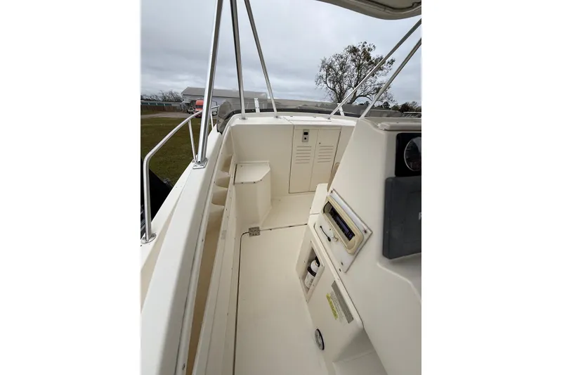 Slide: The Image of 1997 Pursuit 2800 Offshore boat interior with storage compartments and railing. - 26