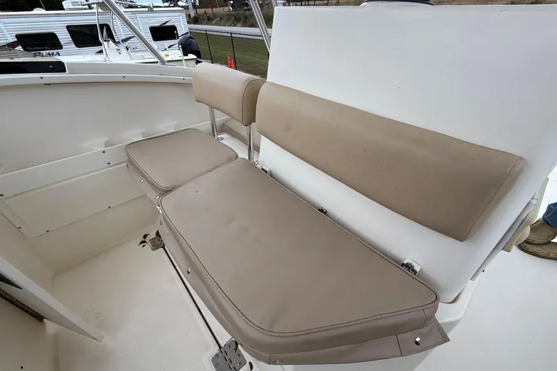 Slide: The Image of 1997 Pursuit 2800 Offshore boat seating with beige cushions, showcasing comfort and style. - 27