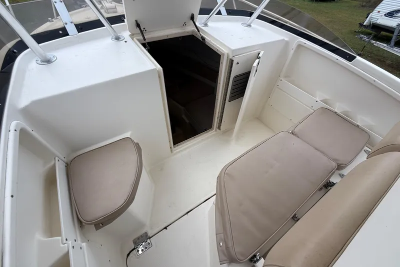 Slide: The Image of 1997 Pursuit 2800 Offshore boat interior with cushioned seating and cabin entrance. - 28
