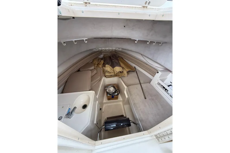 Slide: The Image of 1997 Pursuit 2800 Offshore cabin interior with sink and storage space. - 29