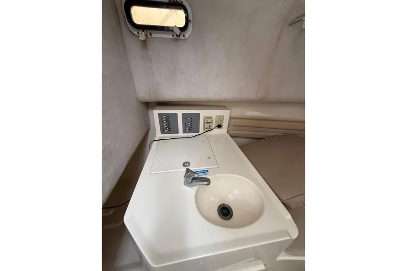 Slide: The Image of 1997 Pursuit 2800 Offshore boat interior with sink and control panel. - 30