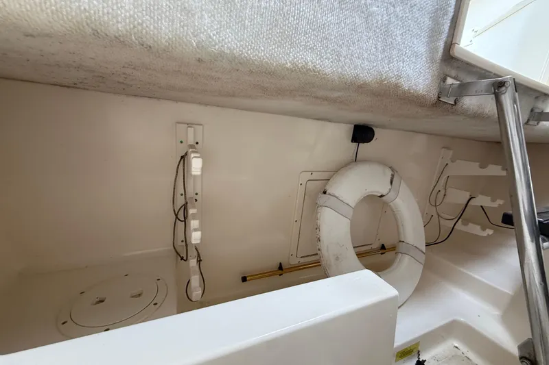 Slide: The Image of Interior of a 1997 Pursuit 2800 Offshore boat with life ring and equipment. - 32