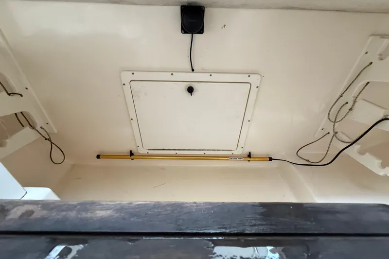 Slide: The Image of 1997 Pursuit 2800 Offshore boat interior with hatch and wiring. - 33