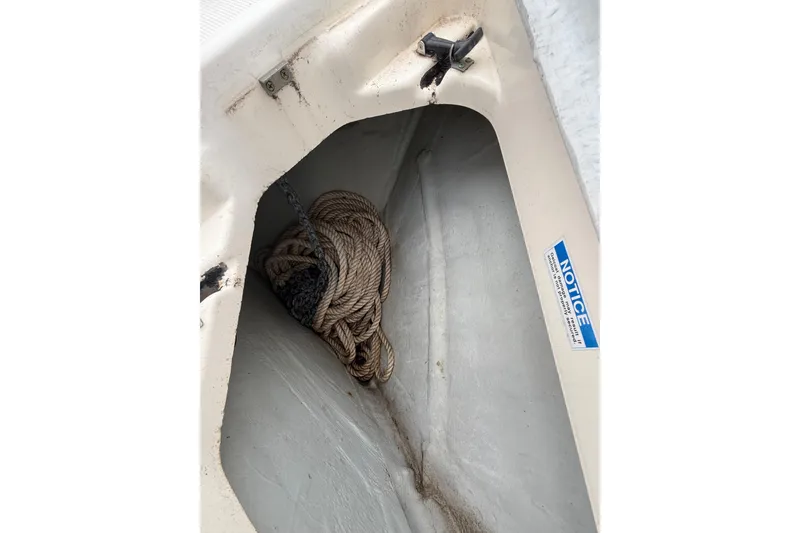 Slide: The Image of Coiled rope in storage compartment of 1997 Pursuit 2800 Offshore boat. - 38