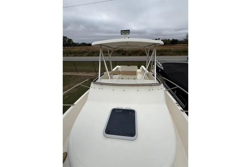 Slide: The Image of 1997 Pursuit 2800 Offshore boat with canopy and deck view. - 39