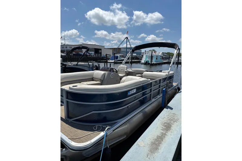 The Image of 2023 Cypress Cay Seabreeze 232 pontoon boat docked under blue sky. - 0