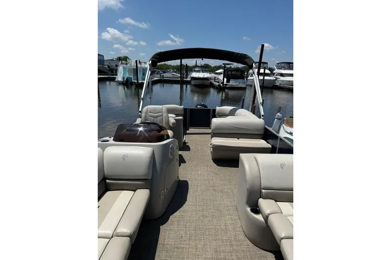 Slide: The Image of 2023 Cypress Cay Seabreeze 232 pontoon boat interior at marina, sunny day. - 3