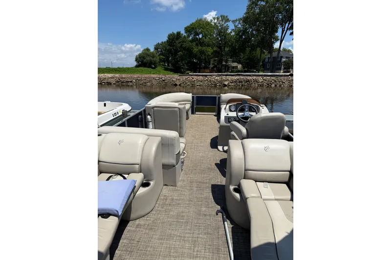 Slide: The Image of 2023 Cypress Cay Seabreeze 232 pontoon boat interior with plush seating and steering console. - 5