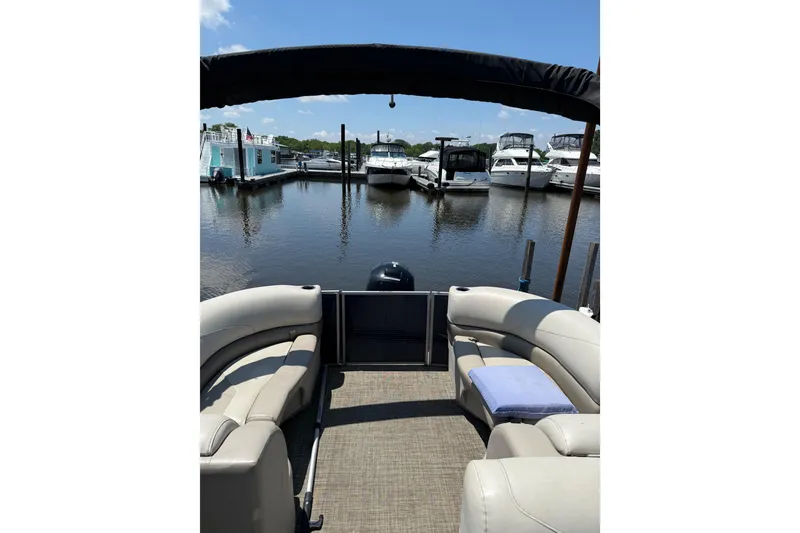 Slide: The Image of 2023 Cypress Cay Seabreeze 232 pontoon boat docked at marina, sunny day. - 6