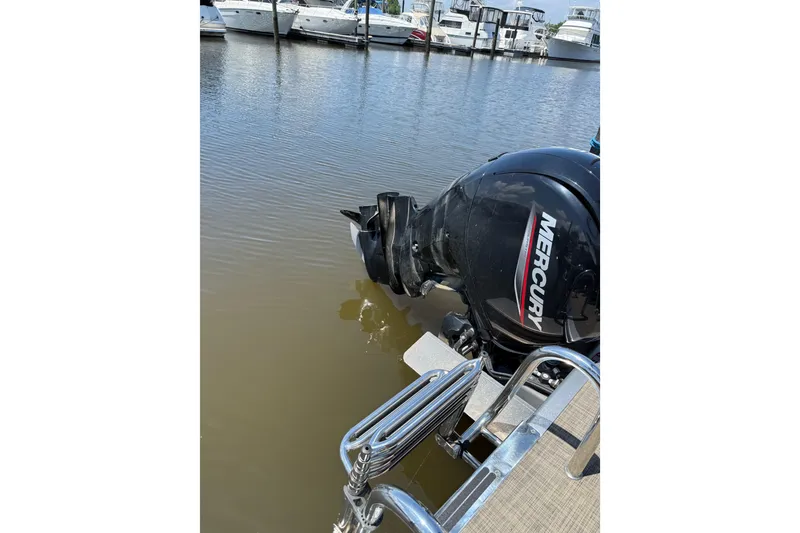 Slide: The Image of 2023 Cypress Cay Seabreeze 232 with Mercury outboard motor at marina dock. - 9