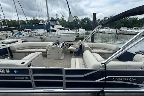 The Image of 2023 Cypress Cay Seabreeze 232 pontoon boat docked at marina, featuring spacious seating. - 1