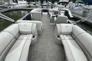 Slide: The Image of 2023 Cypress Cay Seabreeze 232 pontoon boat with spacious seating at marina. - 10
