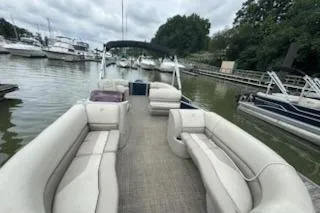 Slide: The Image of 2023 Cypress Cay Seabreeze 232 pontoon boat docked in a marina. - 3