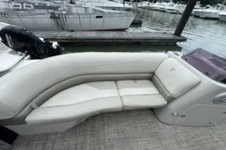 Slide: The Image of 2023 Cypress Cay Seabreeze 232 boat with elegant seating at a marina. - 7